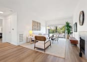 Thumbnail 2 of 54 - A living room with a white couch and a wooden coffee table.