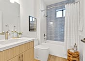 Thumbnail 10 of 54 - A bathroom with a white toilet and a white sink.