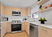 Thumbnail 47 of 54 - A modern kitchen with wooden cabinets and stainless steel appliances.
