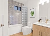 Thumbnail 54 of 54 - A bathroom with a toilet, sink, and shower.