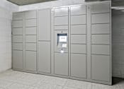 Thumbnail 13 of 54 - A row of grey lockers in a room with a white tiled floor.