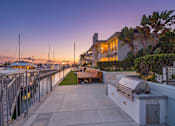 Thumbnail 20 of 251 - A patio with a grill and a table is set up on a dock.