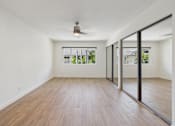 Thumbnail 12 of 251 - A room with wooden flooring and a ceiling fan.