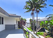 Thumbnail 17 of 251 - A house with a white exterior and a balcony with a metal railing.