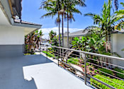 Thumbnail 18 of 251 - A balcony with a metal railing and a white wall.