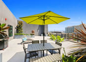 Thumbnail 6 of 31 - a patio with a table and chairs under an umbrella
