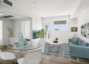 Thumbnail 22 of 31 - a living room with white walls and a glass table with white chairs