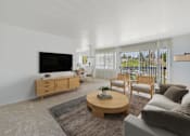Thumbnail 9 of 50 - A living room with a television, couch, and coffee table.