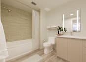 Thumbnail 8 of 163 - A white bathroom with a toilet, sink, and a shower.