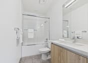 Thumbnail 42 of 45 - A white toilet is in a bathroom with a white sink.