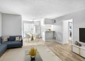 Thumbnail 4 of 10 - a living room and kitchen with a couch and a table