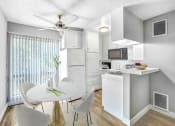 Thumbnail 2 of 10 - an open kitchen and dining room with a white table and chairs