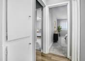 Thumbnail 5 of 10 - an open doorway into a bedroom with a bed and a mirror