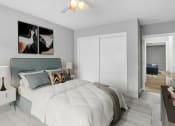 Thumbnail 6 of 10 - a bedroom with a large bed and a ceiling fan