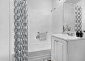 Thumbnail 10 of 10 - a bathroom with a sink and a tub and a shower curtain