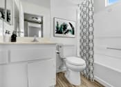 Thumbnail 6 of 11 - a bathroom with a sink and a toilet and a shower