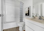 Thumbnail 7 of 11 - a bathroom with a toilet and a shower curtain
