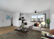 Thumbnail 2 of 10 - a living room with a white couch and a glass coffee table