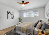 Thumbnail 4 of 10 - a bedroom with a large bed and a ceiling fan