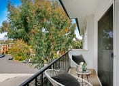 Thumbnail 3 of 10 - a balcony with two chairs and a table