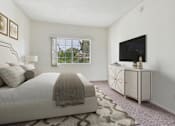 Thumbnail 7 of 17 - A bedroom with a bed, a dresser, and a window.