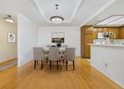Thumbnail 3 of 17 - A dining room with a table and chairs.