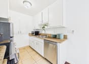 Thumbnail 10 of 82 - A kitchen with white cabinets and a granite countertop.