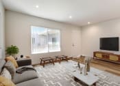 Thumbnail 4 of 76 - a living room with a couch and a tv
