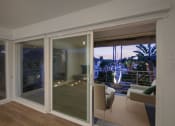 Thumbnail 42 of 135 - a bedroom with a large window and a balcony