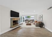 Thumbnail 52 of 135 - a living room with a fireplace and a tv above it