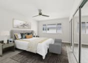 Thumbnail 71 of 135 - a bedroom with a large bed and a sliding glass door to a balcony