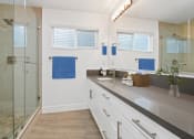 Thumbnail 63 of 135 - a bathroom with white walls and gray countertops