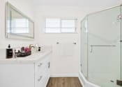 Thumbnail 69 of 135 - a bathroom with white walls and a glass shower