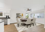 Thumbnail 59 of 135 - a dining room with a table and chairs and a ceiling fan