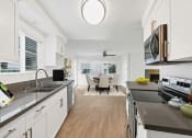 Thumbnail 60 of 135 - a kitchen and dining area in a 555 waverly unit