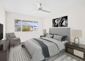 Thumbnail 68 of 135 - a bedroom with white walls and a large window