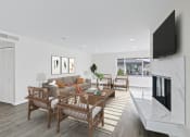 Thumbnail 75 of 135 - a living room with white walls and a fireplace with a tv above it