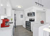 Thumbnail 65 of 135 - a kitchen with white cabinets and a red mixer