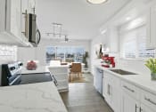 Thumbnail 22 of 135 - a kitchen with white cabinets and a large window