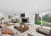 Thumbnail 62 of 135 - a living room with a fireplace and a large window