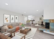 Thumbnail 55 of 135 - a living room with a fireplace and a couch