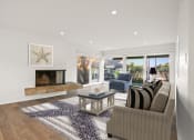 Thumbnail 39 of 135 - a living room with a fireplace and sliding glass doors