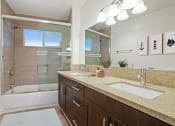 Thumbnail 46 of 135 - a bathroom with a large mirror and two sinks