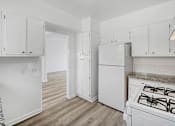 Thumbnail 11 of 20 - a white kitchen with white appliances and white cabinets