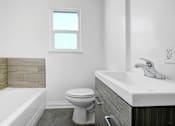 Thumbnail 17 of 20 - a bathroom with a toilet and a sink and a tub