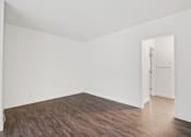 Thumbnail 16 of 38 - an empty room with wood floors and white walls