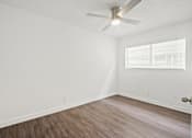 Thumbnail 19 of 38 - the living room of our studio apartment atrium with wood floors and a ceiling fan