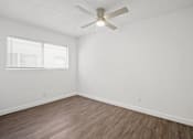 Thumbnail 20 of 38 - an empty room with white walls and a ceiling fan