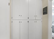 Thumbnail 33 of 38 - a row of white closet doors in a bathroom