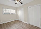 Thumbnail 31 of 38 - an empty bedroom with a ceiling fan and a closet